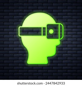 Glowing neon Virtual reality glasses icon isolated on brick wall background. Stereoscopic 3d vr mask. Optical head mounted display.  Vector