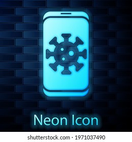 Glowing neon Virus statistics on mobile icon isolated on brick wall background. Corona virus 2019-nCoV. Bacteria and germs, cell cancer, microbe, fungi.  Vector