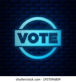 Glowing neon Vote icon isolated on brick wall background.  Vector
