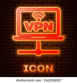Glowing neon VPN Computer network icon isolated on brick wall background. Laptop network. Internet connection.  Vector Illustration