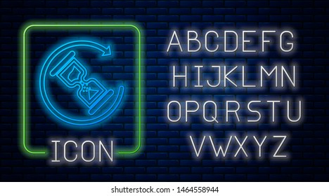 Glowing neon Waiting icon isolated on brick wall background. Wait time icon. Hourglass clock. Neon light alphabet. Vector Illustration