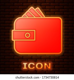 Glowing neon Wallet with stacks paper money cash icon isolated on brick wall background. Purse icon. Cash savings symbol. Vector Illustration