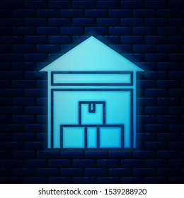 Glowing neon Warehouse icon isolated on brick wall background.  Vector Illustration