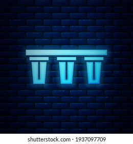Glowing neon Water filter icon isolated on brick wall background. System for filtration of water. Reverse osmosis system.  Vector