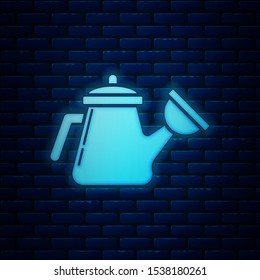 Glowing neon Watering can icon isolated on brick wall background. Irrigation symbol.  Vector Illustration