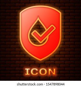 Glowing neon Waterproof icon isolated on brick wall background. Water resistant or liquid protection concept.  Vector Illustration