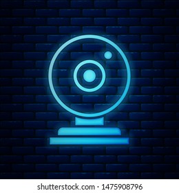 Glowing neon Web camera icon isolated on brick wall background. Chat camera. Webcam icon.  Vector Illustration