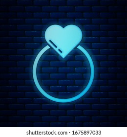 Glowing neon Wedding rings icon isolated on brick wall background. Bride and groom jewelry sign. Marriage symbol. Diamond ring.  Vector Illustration