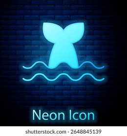 Glowing neon Whale tail in ocean wave icon isolated on brick wall background.  Vector