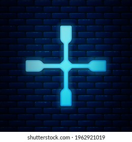 Glowing neon Wheel wrench icon isolated on brick wall background. Wheel brace.  Vector