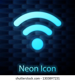Glowing neon Wi-Fi wireless internet network symbol icon isolated on brick wall background. Vector Illustration