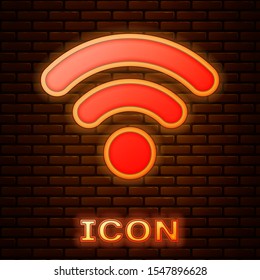 Glowing neon Wi-Fi wireless internet network symbol icon isolated on brick wall background.  Vector Illustration