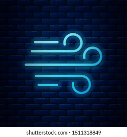 Glowing neon Wind icon isolated on brick wall background. Windy weather.  Vector Illustration