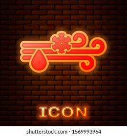 Glowing neon Wind and rain with snow icon isolated on brick wall background. Windy weather.  Vector Illustration