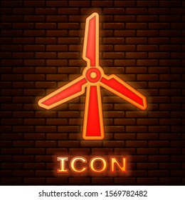 Glowing neon Wind turbine icon isolated on brick wall background. Wind generator sign. Windmill silhouette. Windmill for electric power production.  Vector Illustration