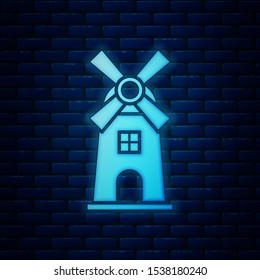Glowing neon Windmill icon isolated on brick wall background.  Vector Illustration