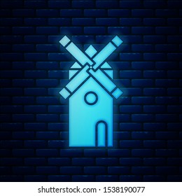 Glowing neon Windmill icon isolated on brick wall background.  Vector Illustration