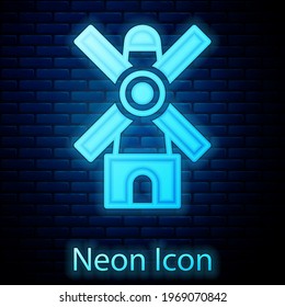 Glowing neon Windmill icon isolated on brick wall background.  Vector