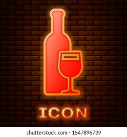 Glowing neon Wine bottle with wine glass icon isolated on brick wall background.  Vector Illustration