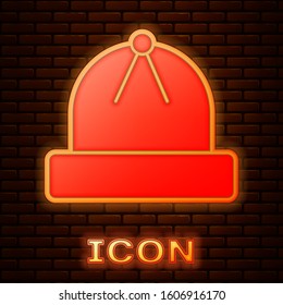 Glowing neon Winter hat icon isolated on brick wall background.  Vector Illustration
