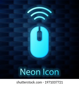 Glowing neon Wireless computer mouse system icon isolated on brick wall background. Internet of things concept with wireless connection.  Vector