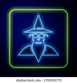 Glowing neon Wizard warlock icon isolated on blue background.  Vector Illustration