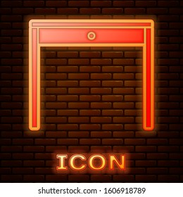 Glowing neon Wooden table icon isolated on brick wall background.  Vector Illustration