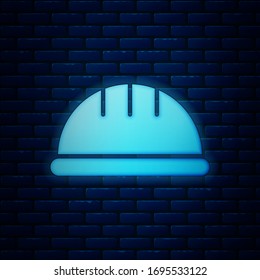 Glowing neon Worker safety helmet icon isolated on brick wall background.  Vector Illustration