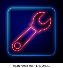 Glowing neon Wrench spanner icon isolated on blue background.  Vector Illustration