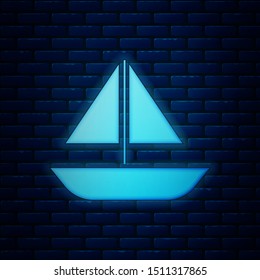 Glowing neon Yacht sailboat or sailing ship icon isolated on brick wall background. Sail boat marine cruise travel.  Vector Illustration
