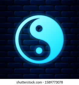 Glowing neon Yin Yang symbol of harmony and balance icon isolated on brick wall background.  Vector Illustration