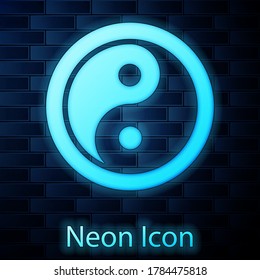 Glowing neon Yin Yang symbol of harmony and balance icon isolated on brick wall background. Vector