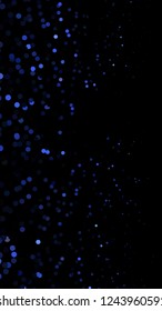 Glowing particles, polka dots on a dark blue background. Vertical festive banner. An elegant holiday pattern. Vector illustration.