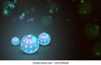 Glowing realistic baubles on black bokeh background can be used as greeting card design with space for your message.