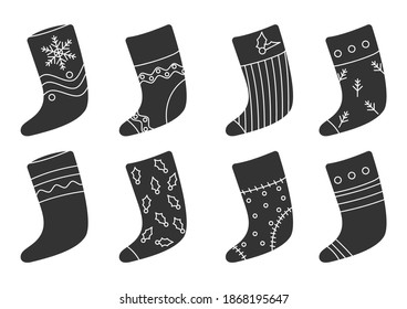 Glyph Christmas sock set. Santa boot with snowflake, berry. Traditional retro Xmas stocking for gift. Accessories for winter presents. Home decoration on New Year Isolated on white vector illustration
