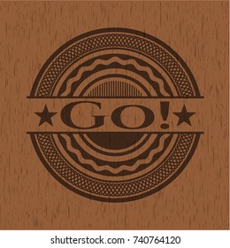 Go! badge with wood background