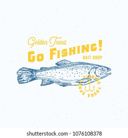 Go Fishing Golden Trout. Abstract Vector Sign, Symbol or Logo Template. Hand Drawn Trout Fish with Classy Retro Typography. Vintage Vector Emblem with Retro Print Effect and Shabby Texture. Isolated.
