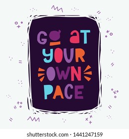 Go At Your Own Pace hand lettering inscription. Multicolor block letters in dark frame. Inspirational and self caring bright color phrase. Hand drawn typography. T-shirt, banner, poster design, cards.