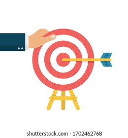 Goal Setting Concept. Hand Holding Bullseye After Hitting by Arrow. Goal Achievement.