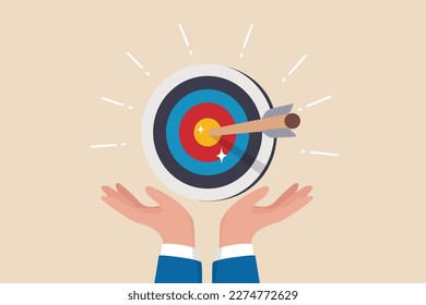 Goal or target, focus and concentration to achieve success, purpose or objective, aiming at target bullseye, accuracy, challenge and aspiration, businessman hand hold target with arrow hit bullseye.