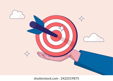 Goal or target. Purpose or objective. Focus and concentration to achieve success, aiming at target bullseye, accuracy, challenge and aspiration, businessman hand hold target with arrow hit bullseye.