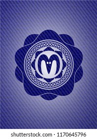 goat head icon inside badge with denim texture