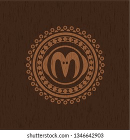 goat head icon inside badge with wooden background