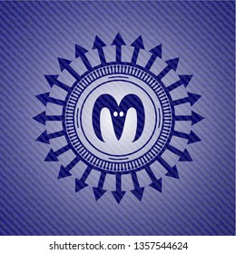 goat head icon inside badge with denim background