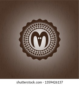 goat head icon inside badge with wooden background