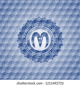 goat head icon inside blue emblem with geometric pattern background.