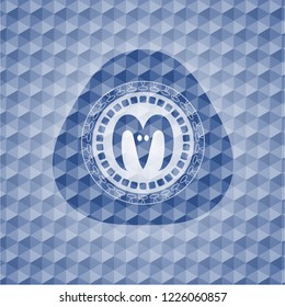 goat head icon inside blue emblem with geometric pattern background.