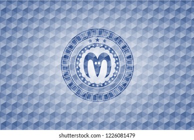 goat head icon inside blue polygonal emblem.