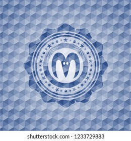 goat head icon inside blue emblem or badge with abstract geometric polygonal pattern background.