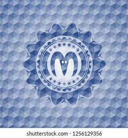 goat head icon inside blue emblem with geometric background.